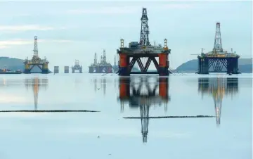  ?? — Reuters ?? Drilling rigs are parked up in the Cromarty Firth near Invergordo­n, Scotland, Britain.