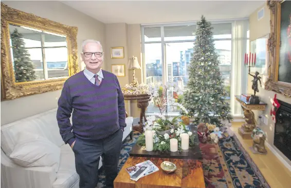  ??  ?? Charles Locker in his living room at Bayview One. The new white down-filled sofa is from Jordans Home. Two matching marble-topped tables, with eagle bases, stand either side of a New York artist’s portrait of an Asian musician. The round table by the...