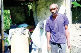  ??  ?? . Aston Bogle, a relative of Paul Bogle, stands in front of the shack where he lives in Stony Gut, St Thomas.