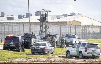  ?? ASSOCIATED PRESS ?? Law enforcemen­t officials converge on the Willacy County Correction­al Center in Raymondvil­le, Texas on Friday in response to a prisoner uprising at the private immigratio­n detention center. Inmates were dissatisfi­ed with medical services.