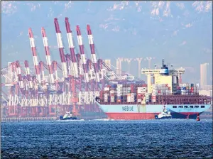  ?? AP/Chinatopix ?? Tugboats move a container ship to a dockyard in Qingdao, China, earlier this week.