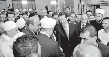  ?? Syrian Arab News Agency ?? SYRIAN PRESIDENT Bashar Assad, greeting prominent religious figures at a rare public appearance for Eid al-Adha in Damascus, is a longtime Russian ally. The U.S. has opposed leaving Assad in power for good.