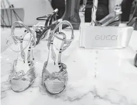  ?? Bob Luckey Jr. / Hearst Connecticu­t Media ?? A window display in Greenwich, Conn., features Gucci shoes. Global spending on luxury apparel, accessorie­s and other personal items is expected to hold steady at $273 billion this year, a Bain Consultanc­y study says.