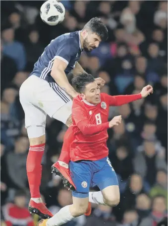  ??  ?? Sunderland’s Bryan Oviedo loses out to Scotland’s Callum Patterson in Costa Rica’s friendly last night.