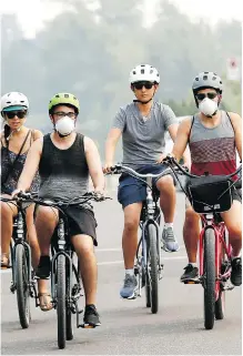  ?? DARREN MAKOWICHUK ?? Andrea, Ken, Chuck and Michael ride along Crescent Hill. The city’s air quality was considered high risk on Thursday.