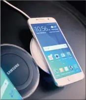  ?? PHOTO: AP ?? Samsung's new Galaxy S6 series phones are shown on a wireless charger, during a special press preview in New York.
