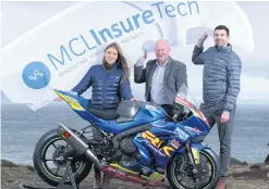  ??  ?? Revved up: Laura Scott and Rick Bell from MCL InsureTech are welcomed on board by NW200 event director Mervyn Whyte