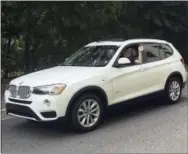  ??  ?? Journalist Scott Mayerowitz drives a white BMW X3 SUV, which was an upgraded rental car in Orlando, Fla., thanks to elite status in the National Car Rental program. Members of car rental loyalty programs, even those without status, get to skip the...