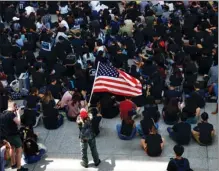  ?? CHINA DAILY ?? Protesters occupy the arrival hall of Hong Kong Internatio­nal Airport on Friday, with one participan­t waving a US national flag and inviting Washington to “weigh in” on the turmoil in the city.