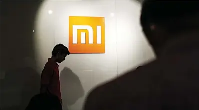  ?? DHIRAJ SINGH / BLOOMBERG ?? Mainland electronic­s giant Xiaomi Inc has become the first company to apply for dual-class share listing on the Hong Kong Stock Exchange since the city’s bourse began accepting listing applicatio­ns on April 30. investment manager at Tengard Fund...