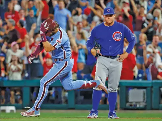  ?? CHRIS SZAGOLA/AP ?? Bryce Harper rounds first base in front of Anthony Rizzo on his walk-off grand slam off Cubs left-hander Derek Holland on Thursday night.