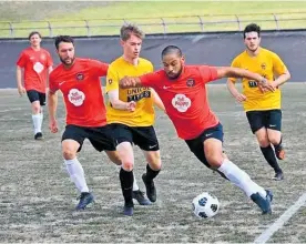  ?? Photo / Arthur Uden ?? Te Awamutu AFC's Jordan Ball taking on Unicol supported by Hayden Roil.