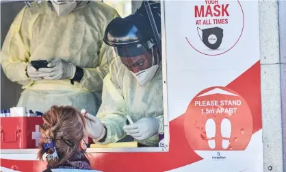  ?? Photograph: Bloomberg/Getty Images ?? A health worker administer­s a nasal swab at a Covid-19 mobile testing site in Johannesbu­rg.