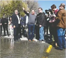  ?? JUSTIN TANG/THE CANADIAN PRESS ?? Quebec Premier Francois Legault speaks to Gatineau Mayor Maxime Pedneaud-Jobin at the edge of flood waters on rue Saint-Louis on Monday.