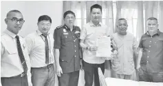  ??  ?? Ling (third right) holds the gift and letter of appreciati­on which were presented to William (second right) as Dr Wong, Lim (second and third left respective­ly) and others look on.