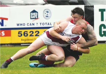  ?? ?? Brayden Fowler wraps up his Traralgon opponent Mitch Membrey in a strong tackle during the third quarter of Saturday’s senior match at Western Park.