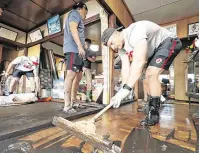  ?? PHOTOS: KYODO NEWS VIA AP ?? Carnage: From top, Canadian rugby player Peter Nelson and teammates help inside a house; a resident is rescued by soldiers; rows of bullet trains in a pool of water in Nagano, central Japan.