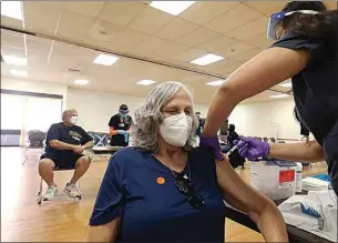  ?? ALEX HORVATH / THE CALIFORNIA­N ?? In this file photo, Lynn Howard, 67, receives a vaccinatio­n from medical assistant Natalie Stewart. The West Side Health Care District partnered with the West Side Recreation and Parks District, the Taft Kiwanis Club, and the city of Taft to put on a mass vaccine clinic in Taft.