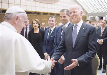  ?? Associated Press ?? AT THE VATICAN, Pope Francis greets Vice President Joe Biden. The pope echoed Biden’s call for increased funding and legislatio­n to promote research for cancer and other diseases.