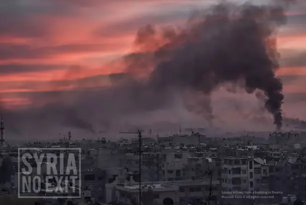  ?? ?? Smoke billows from a building in Douma Mouneb Taim © All rights reserved