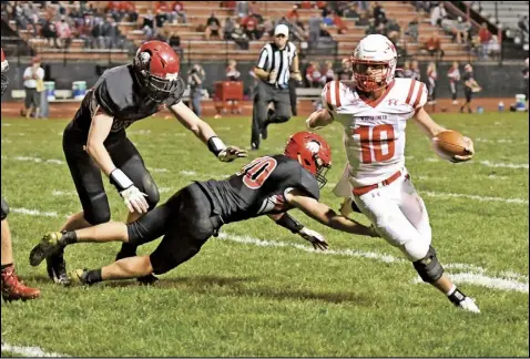  ?? Photo by John Zwez ?? Braeden Goulet of Wapakoneta eludes a tackle attempt by Shawnee during Friday’s Region 12 playoff game. The Redskins won the game 15- 0. See more photos at wapakdaily­news. com.