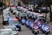  ?? DAI SUGANO — STAFF PHOTOGRAPH­ER ?? Oakland Police officers escort the Alameda County Sheriff's coroner's vehicle as they depart Highland Hospital in Oakland on Friday.