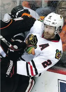  ?? STEPHEN DUNN/ GETTY IMAGES ?? Duncan Keith, right, has taken his share of hits from the opposition in the Hawks’ run to the Stanley Cup final.