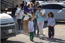  ?? (John Moore/Getty Images/TNS) ?? Immigrant families from Venezuela arrive back in Ciudad Juarez, Mexico, after being expelled Jan. 9 from the United States.