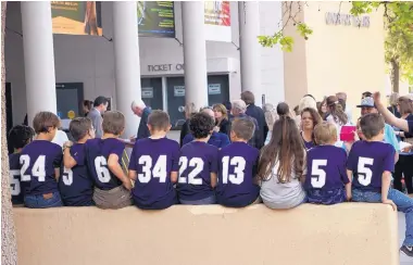  ?? ADOLPHE PIERRE-LOUIS/JOURNAL ?? Baseball teammates of Josh Riordan wait outside Popejoy Hall on Sunday before attending the memorial for their friend’s mother, Jennifer Riordan, who was killed in an airplane accident Tuesday.