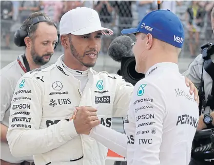  ??  ?? Mercedes drivers Lewis Hamilton, left, and Valtteri Bottas during the US Grand Prix.