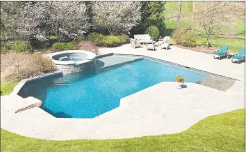  ?? William Raveis Real Estate / Contribute­d photo ?? Complete with a Pebble Tec pool and spa and a spectacula­r lower level bar, media room and wine cellar, the home was designed to be the place where everyone wants to gather.