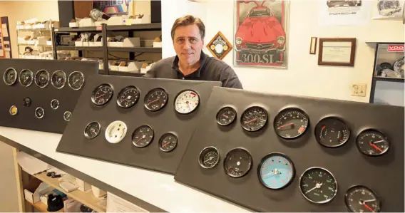  ??  ?? Below: Ralph Klink shows off the instrument displays used in the showroom and at the many car shows attended