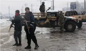  ?? Photograph: Anadolu Agency via Getty Images ?? Afghan security force members guard the scene of a suicide attack that targeted the entrance gate of Marshal Fahim military academy in Kabul, Afghanista­n on Tuesday.