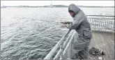  ?? Arnold Gold / Hearst Connecticu­t Media ?? Harold Herring of Hamden fishes in New Haven Harbor from a pier off of South Water Street in New Haven on Tuesday.