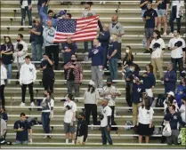  ?? FRANK FRANKLIN II - THE ASSOCIATED PRESS ?? Fans stand during the playing of the national anthem before a baseball game between the New York Yankees and the Houston Astros Tuesday, May 4, 2021, in New York.