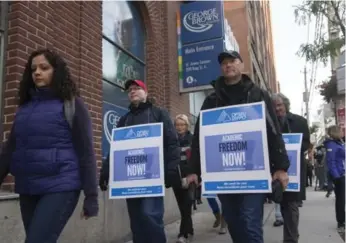  ?? BERNARD WEIL/TORONTO STAR ?? Striking teachers picket outside George Brown College’s St. James Campus on King St. in Toronto Tuesday.