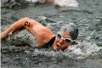  ??  ?? Pro competitor Adam O’Meara swims in to the first transition at Ross’s Landing during Ironman Chattanoog­a on Sunday.