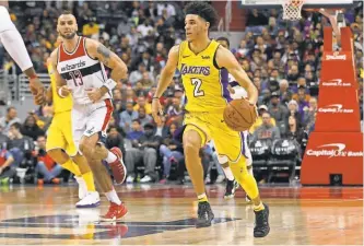  ?? GEOFF BURKE/ USA TODAY SPORTS ?? Los Angeles Lakers guard Lonzo Ball ( 2) dribbles the ball as Washington Wizards center Marcin Gortat ( 13) chases during the third quarter at Capital One Arena.