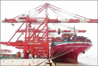  ?? ?? In this photo released by Xinhua News Agency, a container ship from Japan is anchored at the container dock of Shanghai’s Yangshan Port in east China on April 27, 2022. China’s export growth tumbled in April after Shanghai and other industrial cities were shut down to fight virus outbreaks. (AP)