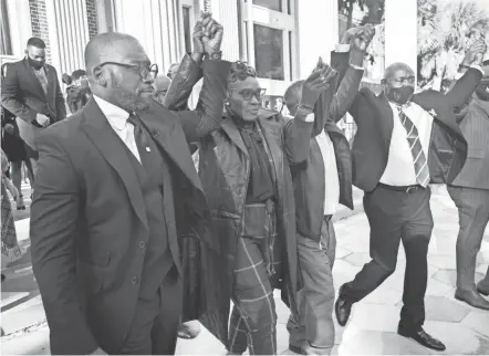  ?? STEPHEN B. MORTON/AP ?? Ahmaud Arbery’s mother Wanda Cooper-jones, center, walks out of the Glynn County Courthouse in Georgia after a judge sentenced Greg Mcmichael, Travis Mcmichael and William “Roddie” Bryan to life in prison for killing Arbery in 2020.