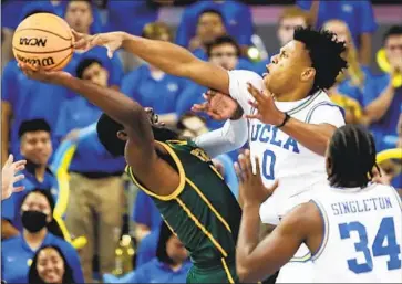  ?? Allen J. Schaben Los Angeles Times ?? UCLA guard Jaylen Clark blocks a shot by Norfolk State guard Joe Bryant Jr. Clark led everyone with 19 points on seven-for-11 shooting, including a career-high five three-pointers, nine rebounds, two steals and a block.