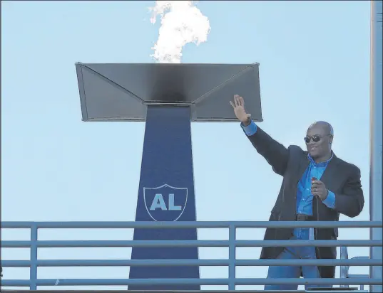  ?? Ben Margot The Associated Press ?? Bo Jackson waves after lighting a torch for late Raiders owner Al Davis before a game in Oakland against the Titans in 2013. Jackson played in 38 games with the Raiders in Los Angeles from 1987 to 1990, running for 2,782 yards and 16 touchdowns.