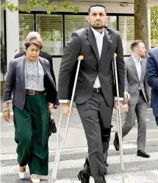  ?? — AFP photo ?? Kyrgios arrives on crutches to the magistrate’s court in Canberra with his Malaysia-born mother Norlaila.