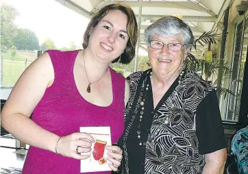  ??  ?? Tara Langres received a 10 year service award from chairman Shirley Grove at the recent Red Cross Christmas dinner.