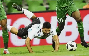  ??  ?? Down and out: Argentina’s Sergio Aguero goes tumbling as he challenges for the ball with two Nigeria players in Krasnodar, Russia, on Tuesday. — AP