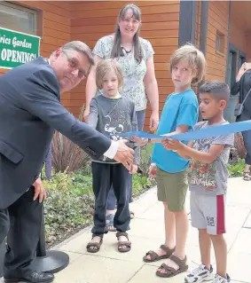  ??  ?? Deputy Mayor of Hillingdon Cllr John Morgan cuts the ribbon at the Peter Pan ward garden at Hillingdon Hospital