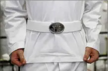  ?? AP file photo ?? An Incoming plebe adjusts their uniform during Induction Day at the U.S. Naval Academy, June 27, 2019, in Annapolis, Md. Reported sexual assaults at the U.S. military academies shot up during the 2021-22 school year, and one in five female students surveyed said they experience­d unwanted sexual contact, the Associated Press has learned.