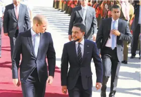  ?? Khalil Mazraawi / AFP / Getty Images ?? Prince William (left) is greeted in Amman, Jordan, by Crown Prince Hussein. William also will pay official visits to Israel and the Palestinia­n territorie­s.