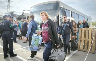  ?? AP-Yonhap ?? People arrive from the Ukrainian city of Mariupol at a center for displaced people in Zaporizhzh­ia, Ukraine, Tuesday. Around 100 civilians were evacuated from the steel plant, the last Ukrainian-controlled area in the southern port city of Mariupol, according to Ukrainian officials.