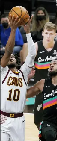  ?? ERIC GAY - ASSOCIATED PRESS ?? Cavaliers guard Darius Garland scores past Spurs guard Derrick White during the second half of the Cavs’ 125-101 win April 5.